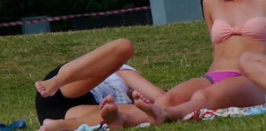 Three sexy girls in bikinis exercising at the park