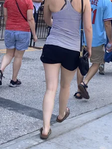 Bunch of girls in various outfits at a Cardinals baseball game