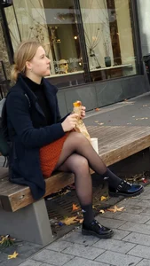 Candid Girl in a Skirt And Black Pantyhose Eating a Snack on a Street Bench Creepshot