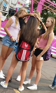 Bunch of skinny teens in shorts at the fun fair
