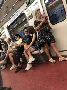 Hot Girl With Gorgeous Legs in Jean Shorts And Sneakers Sitting in a Subway Train With Crossed Legs - Touching And Swinging Her Legs