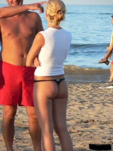 A bunch of hot babes on the beach in thong bikinis