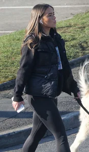 Pouting brunette teen in black leggings