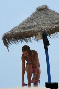 Hot beach girl undressing and going topless