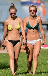 Sexy blonde girl in the park playing volleyball in her skimpy bikini
