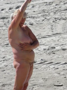 Mature blonde lady on a nude beach with big boobs