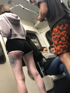 A Tall And Slim Candid Girl in Spandex Shorts in a Hoodie Top, With Tattoos on Her Long Legs Subway Creepshots