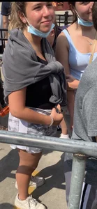 Teen with braces waiting in line for a ride