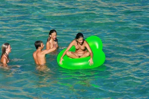 FKK Nudists playing in the water with floater