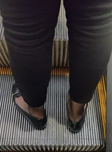 Candid girls' legs closeups on the escalator