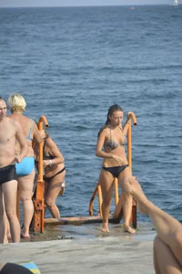 Sexy skinny babe in thong bikini on the beach