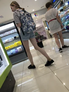 Girl in Blue Denim Shorts with Very Skinny Legs Store Candid