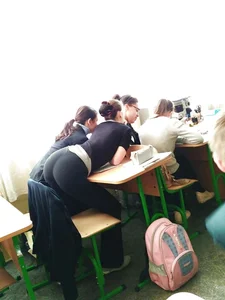 College Girl in Yoga Pants Bending Over the Desk in Classroom Candid Photo