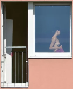 Peeping Tom pics of a topless girl in her house with nice tits