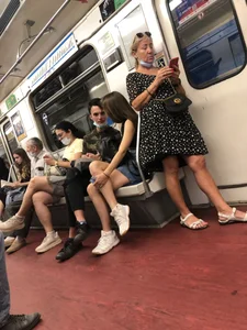 Hot Girl With Gorgeous Legs in Jean Shorts And Sneakers Sitting in a Subway Train With Crossed Legs - Touching And Swinging Her Legs