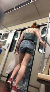 Two Girls With Hot Long Legs in Mini Shorts and Sneakers in the Subway Train Candid Photo Gallery