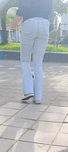 Tall candid teen wearing tight jeans playing on the street