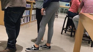 Blonde teen shopping at an Apple store in tight grey leggings