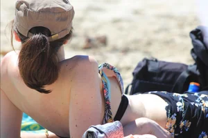 Sexy girls topless on a nude beach showing their nice tits