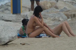 Topless girls on a beach in Barcelona
