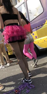 Hot carnival girl in in a top, mini shorts with pink frill and awesome legs in fishnet pantyhose