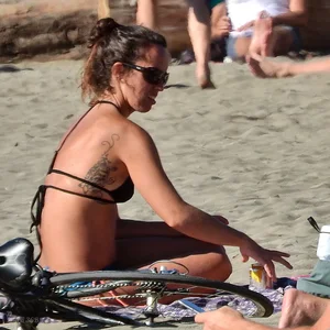 Lady in blue and black bikini at the beach with a nice body