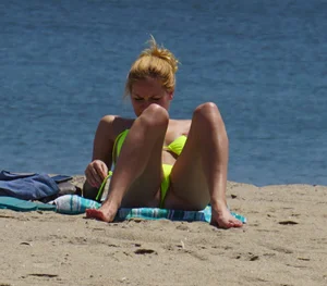 Sexy ass blonde milf on the beach in a thong with cameltoe and bending over