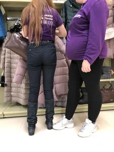 Cute candid shop assistant wearing boots and tight pants