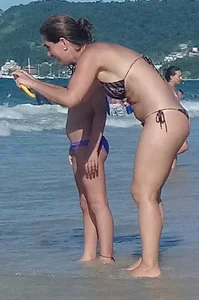 Milf on the beach in a thong bikini