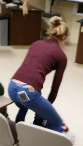 Blonde student in jeans showing her blue thong whale tail