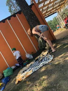 Young Skinny Girl Taking Off Her Denim Shorts Leaving a Swimsuit - Bending Over While Laying a Blanket on the Ground at a Lake Nature Park Gallery
