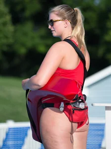 Thick blonde lifeguard in red swimsuit