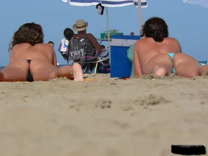2 topless thonged sexy friends on the beach with great bodies