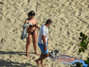 Big booty beach babe laying out in thong