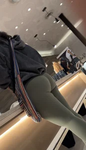 Sexy bubble butt in tight green leggings at the mall