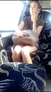 Girl in a Skirt Speaking in the Phone in a Bus