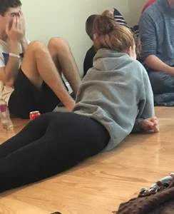 Candid teen in leggings laying on the floor