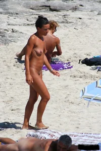 Smoking milf at a nude beach with a hairy pussy