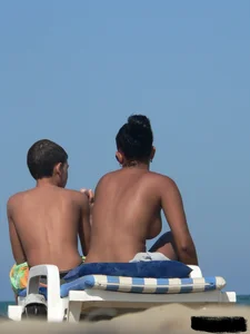 Hot ass topless beach girl with great tits lets her little brother oil up her ass in thong bikini