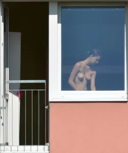 Peeping Tom pics of a topless girl in her house with nice tits