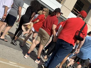 Bunch of girls in various outfits at a Cardinals baseball game