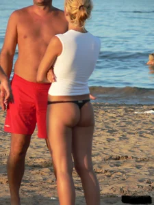 A bunch of hot babes on the beach in thong bikinis