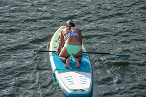 Busty chick in bikini bends over
