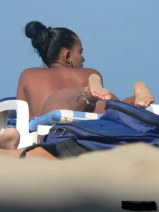 Hot ass topless beach girl with great tits lets her little brother oil up her ass in thong bikini