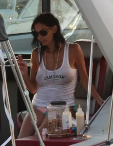 Bikini babe on a boat with a wet see through white shirt showing her tits