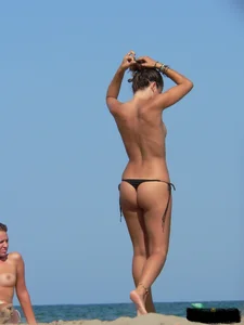 2 topless thonged sexy friends on the beach with great bodies