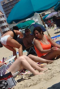 Beach girl with big boobs in an orange swimsuit