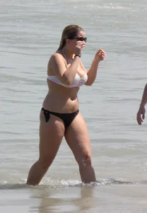 Big boobed thick blonde on the beach in a bikini