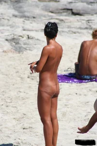 Smoking milf at a nude beach with a hairy pussy
