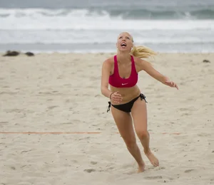 Hot girls playing beach volleyball in bikinis and shorts